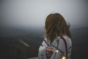 Woman looking into distance reflecting on grief and loss, representing emotional healing and grief counseling in Temecula